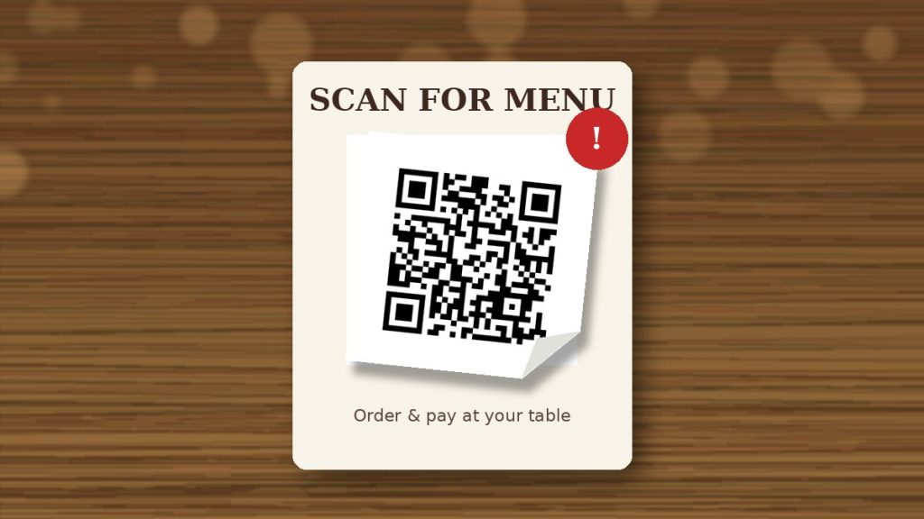 Fake QR code sticker over a restaurant menu code Restaurant table card with a menu QR code covered by a fake QR code sticker peeling at the corner